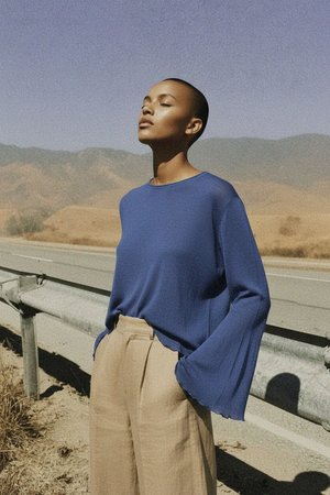 Blue Knit Top with Ruffled Hem and Cuffs